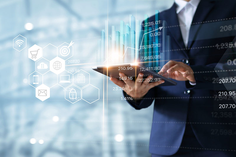 Business person using a tablet overlayed with graphs and charts